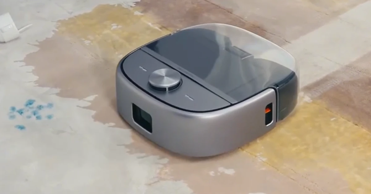 Robotin R2 robot vacuum and carper cleaner cleaning up a spilt beverage on a carpet leaving a visible clean path